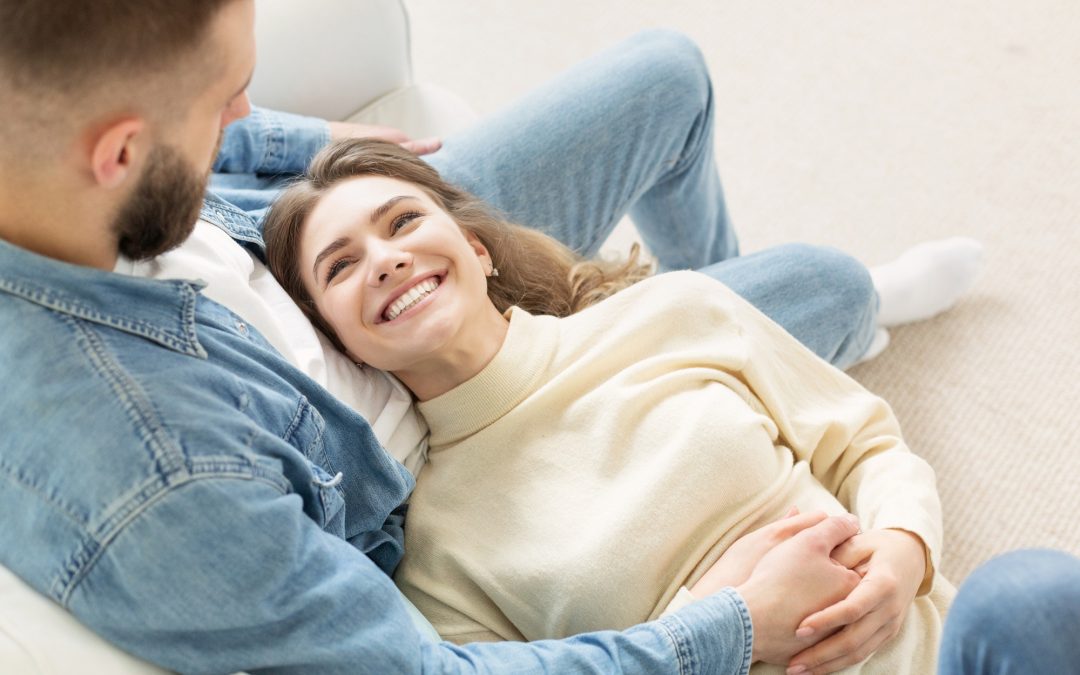 Loving couple relaxing on sofa, cozy warm leisure day